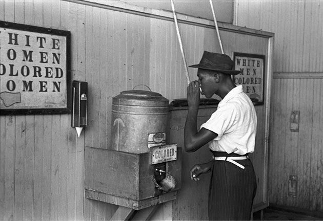 Man Drinks from A Colored Only Drinking Fountain Circa 1950s