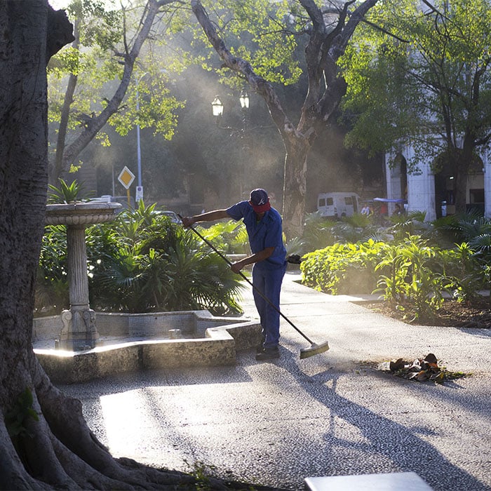 Man sweeping Parque Central in Havana