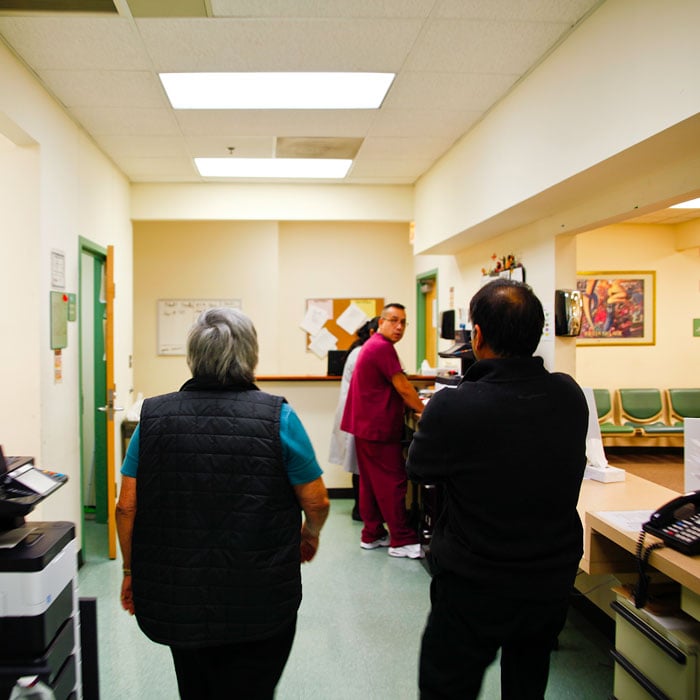 Carmen Velásquez walks through the clinic with Dr. Bhurgri