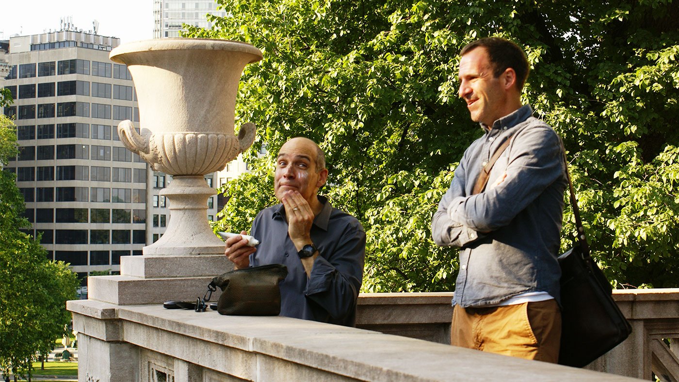 Geoffrey Baer gets camera-ready while talking with Series Producer Dan Protess during a shoot in Boston, Massachusetts