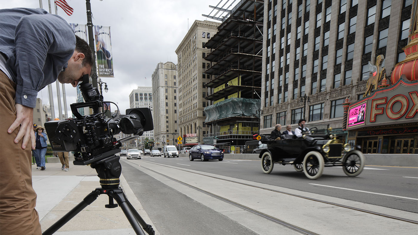 Series Producer Dan Protess looks through the viewfinder during a shoot along Woodward Avenue in Detroit, Michigan
