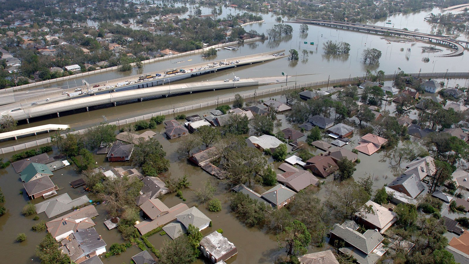 A flooded New Orleans neighborhood with a roadway going down into flood waters after Hurricane Katrina on August 29, 2005