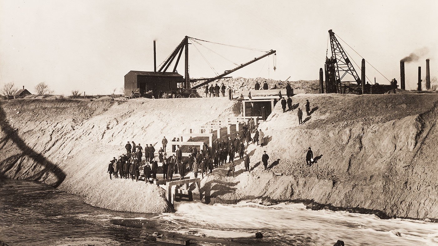 Sanitary District trustees and others pose for a photo after breaking the last dam holding the Chicago River back from the Sanitary and Ship Canal on the morning of January 2, 1900