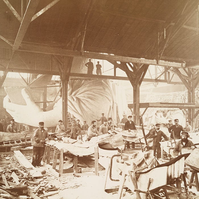 Men in Bartholdi’s workshop in Paris, hammering sheets of copper for the construction of the Statue of Liberty, 1883