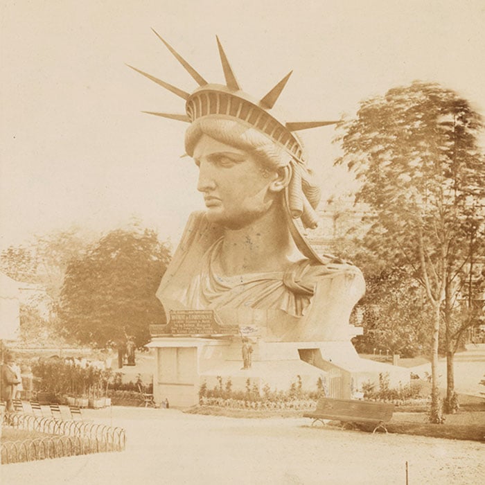 The head of the Statue of Liberty on display in a park in Paris. Photo by Albert Fernique, 1883