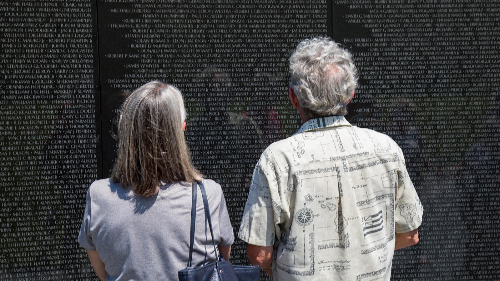 Visitors read the names of the dead or missing at the Vietnam Veterans Memorial in Washington, D.C.