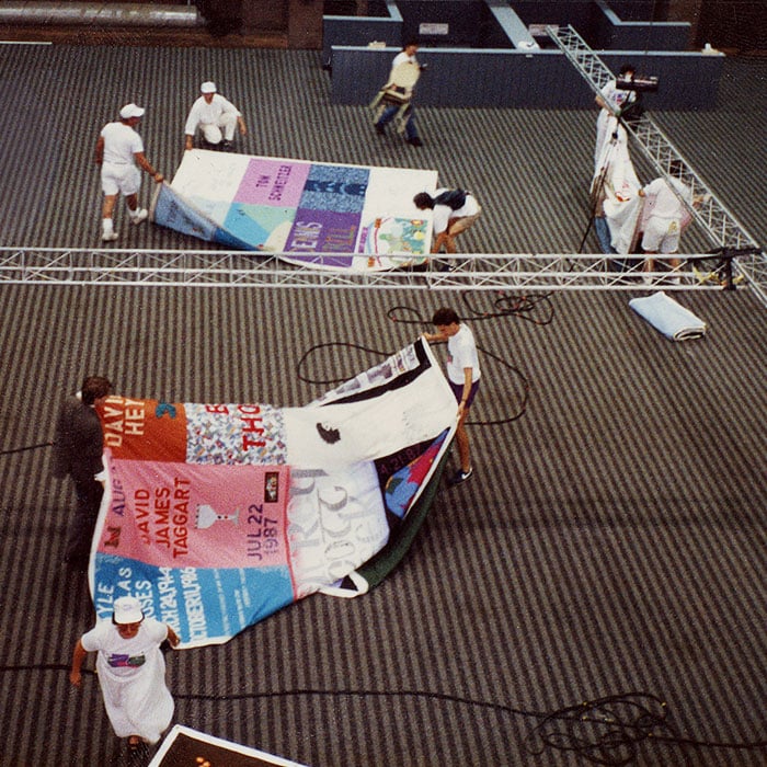Volunteers unfurl the AIDS Memorial Quilt at an event in Boston, Massachusetts