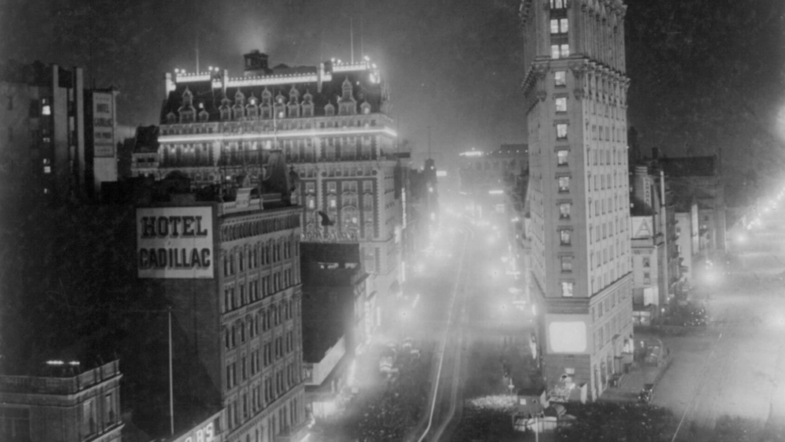 Broadway and West 42nd Street at night, with crowds gathered to see films projected outdoors, circa 1908