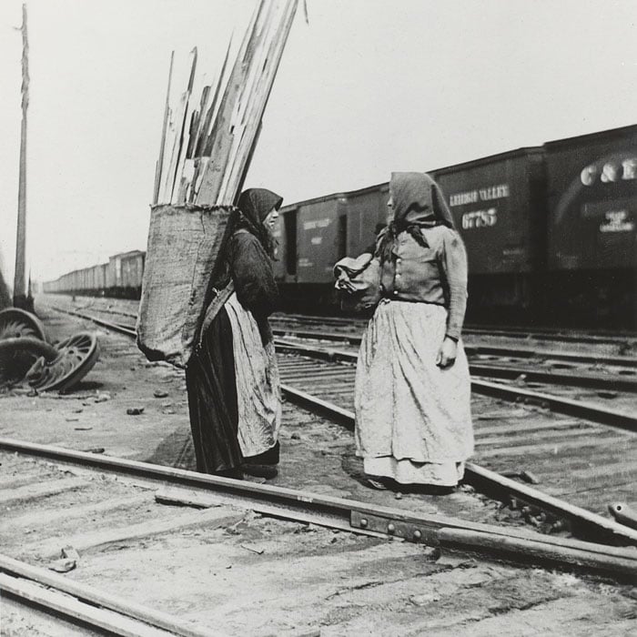 Women collect scrap wood from the Yards.