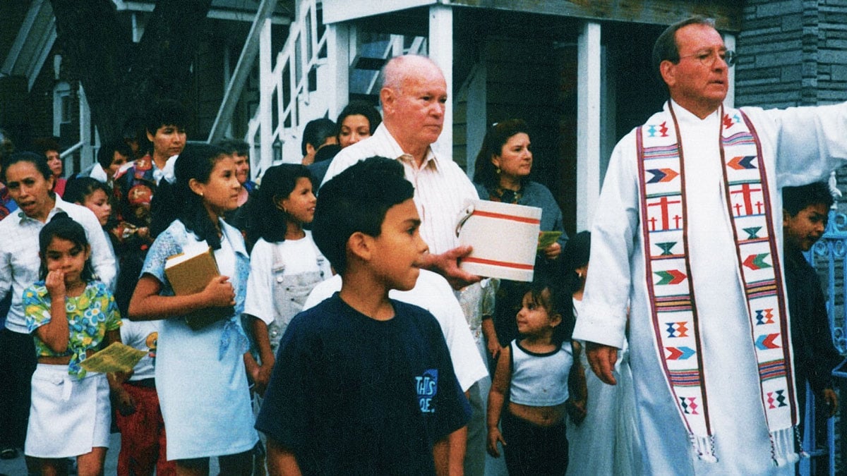 Father Charles Dahm blessing Pilsen’s streets during mass.