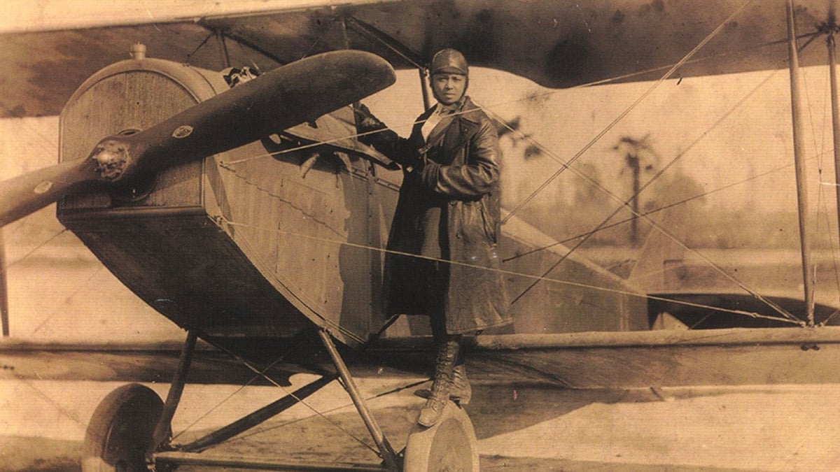 Bessie Coleman with her plane