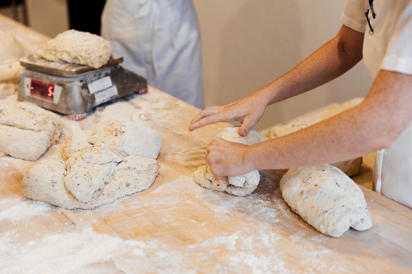 Dough is folded and weighed