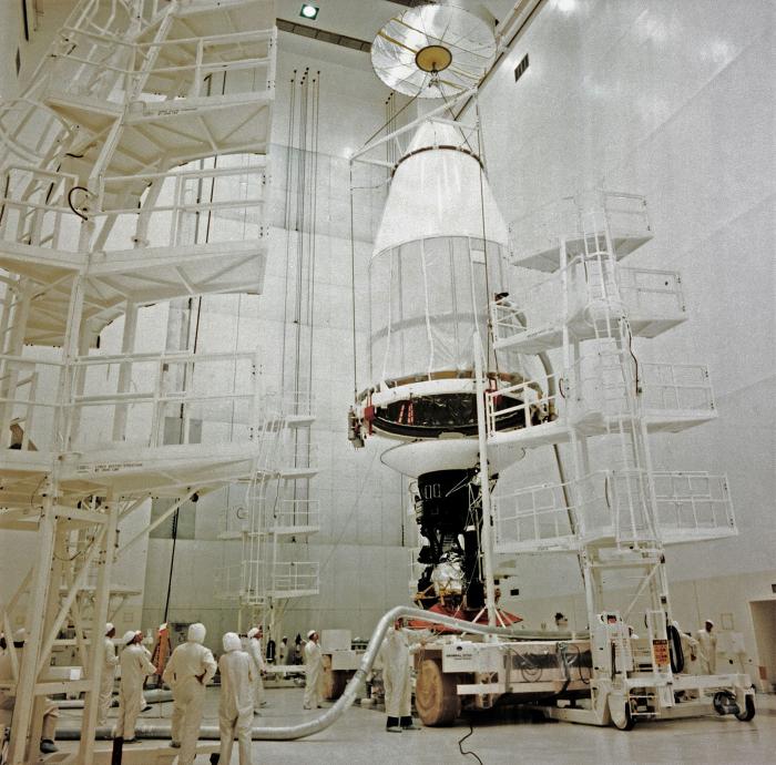 The capsule being placed over the Voyager spacecraft at NASA. Photo: NASA