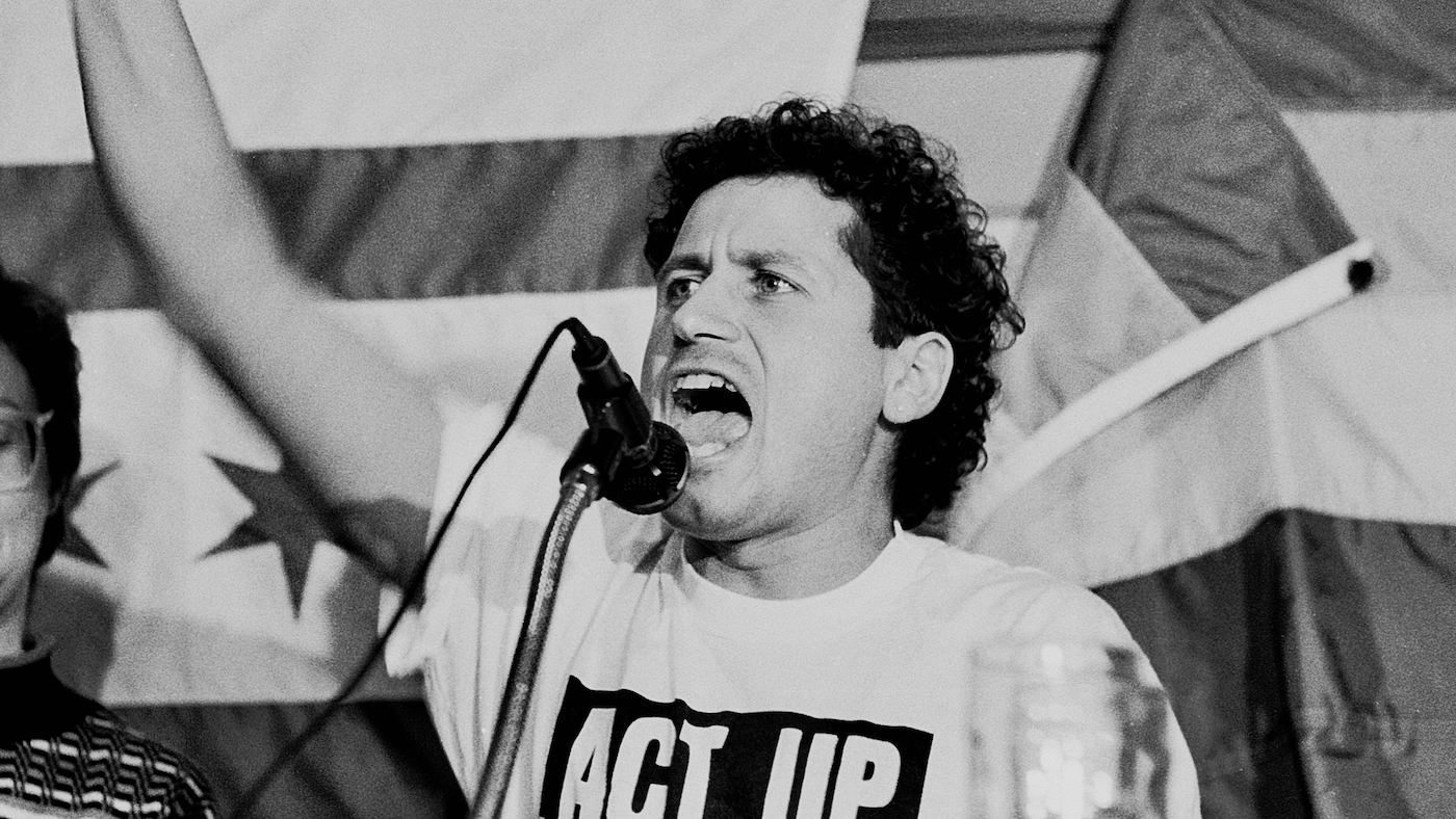 Chicago AIDS activist Danny Sotomayor speaks at a microphone at a rally
