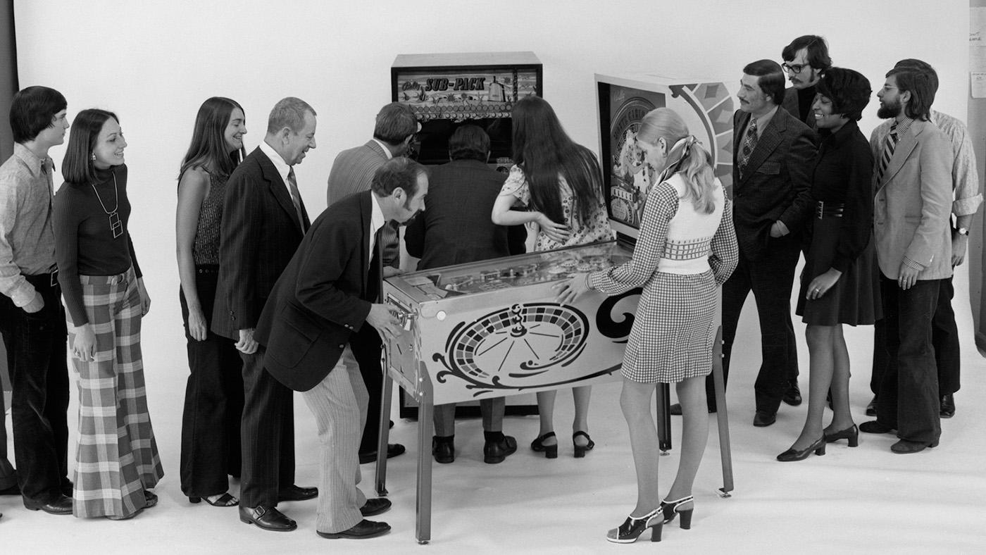 Women and men standing around a Bally pinball machine, Chicago, Illinois, 1973. Credit: HB-37121-A, Chicago History Museum, Hedrich-Blessing Collection