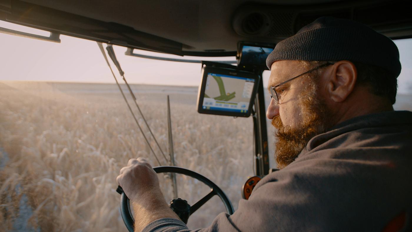Jeff Ditzenberger drives a piece of machinery through a farm field