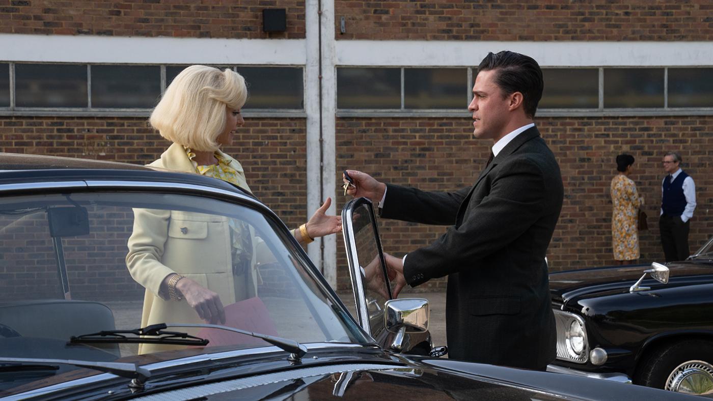 Matthew hands Trixie keys next to a car