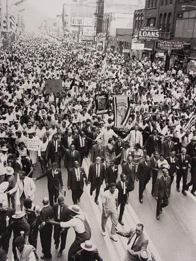 Martin Luther King, Jr. (center, bottom third of image) marches along State Street in 1966 as part of the Chicago Freedom Movement. Photo: Chicago Defender Archives