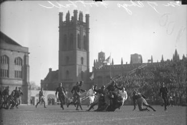 Football players grappling on University of Chicago’s Stagg Field in 1929