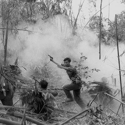 North Vietnamese Army officer leads an attack on South Vietnamese forces. Laos 1971. Photo: Doug Niven