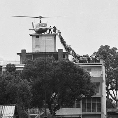 South Vietnamese civilians scramble to board a helicopter during the evacuation of Saigon. April 29, 1975. Photo: Hubert (Hugh) Van Es/Getty Images