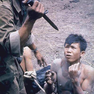 South Vietnamese soldier threatens a Viet Cong suspect. 1962. Photo: Larry Burrows/Getty Images