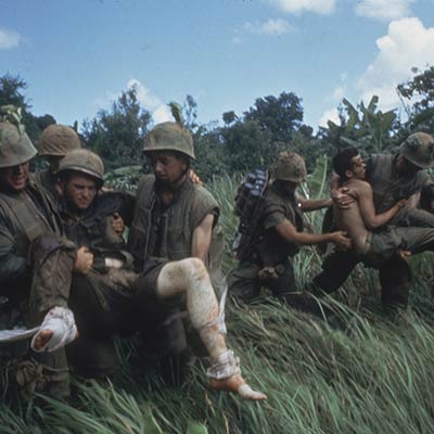 Marines carrying their wounded during firefight near the DMZ. 1966. Photo: Larry Burrows/Getty Images