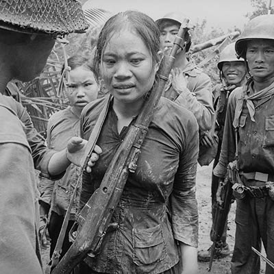 Suspected Viet Cong soldier carrying a Russian-made rifle, awaiting interrogation. August 25, 1965. Photo: Associated Press