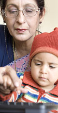 [photo: woman teaching child]