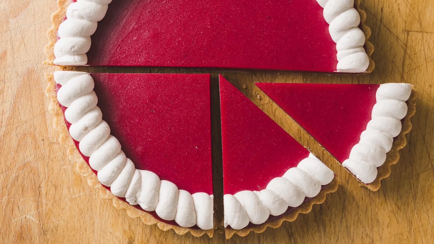 A close-up of cranberry curd tart, sliced into a few pieces