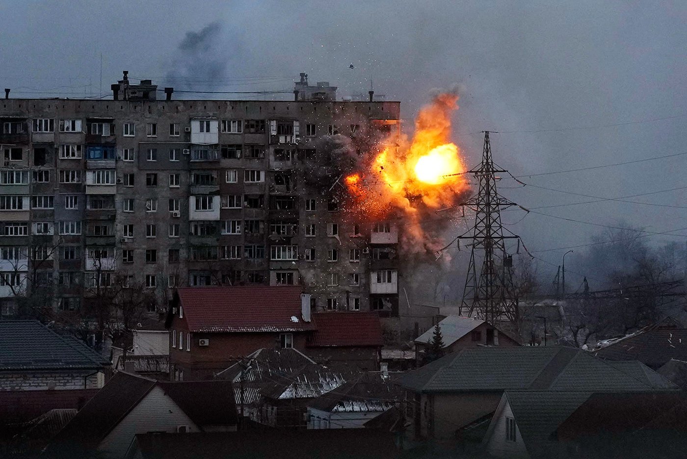 An explosion is seen in an apartment building after Russian's army tank fires in Mariupol, Ukraine, March 11, 2022. Still from FRONTLINE PBS and AP’s feature film “20 Days in Mariupol.” Credit: AP Photo/Evgeniy Maloletka