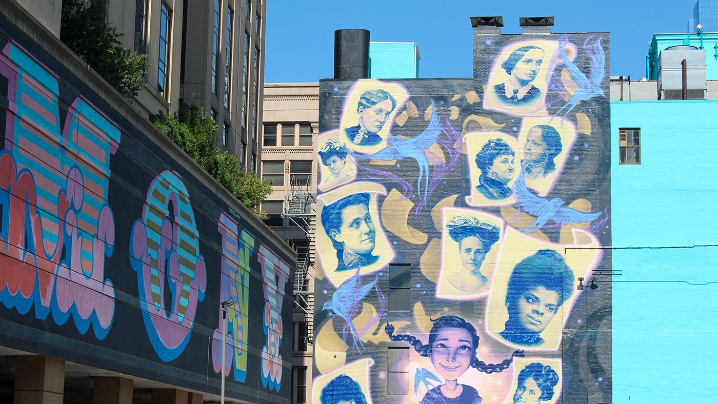 A mural of famous women's faces in the South Loop of Chicago