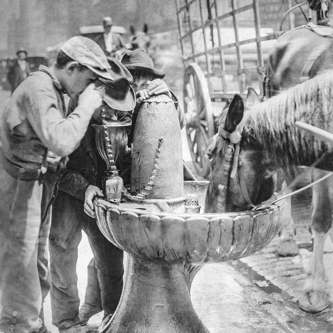 boys and a horse share a drinking fountain in 1887