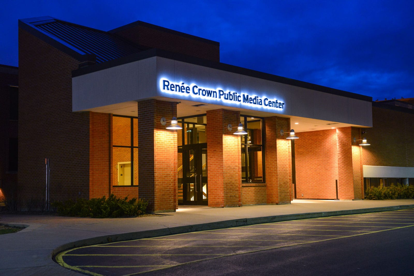 View of Renee Crown Public Media Center exterior at night