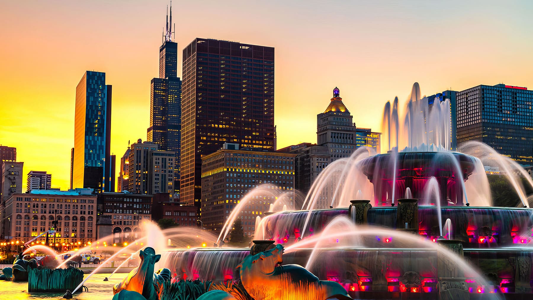 Buckingham Fountain in the foreground, with the Willis Tower and other downtown Chicago buildings in the background.