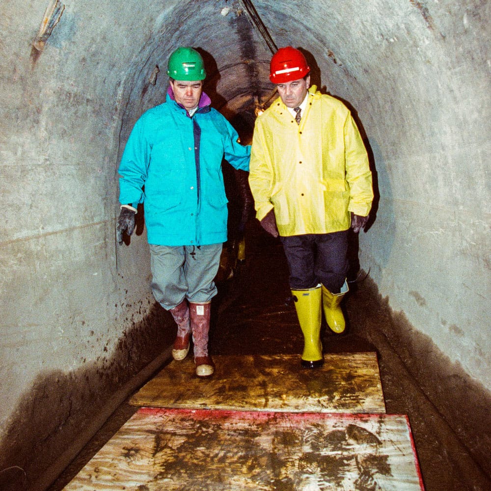 John Kenny, left, showing Mayor Richard M. Daley through the tunnels in the months after the flood