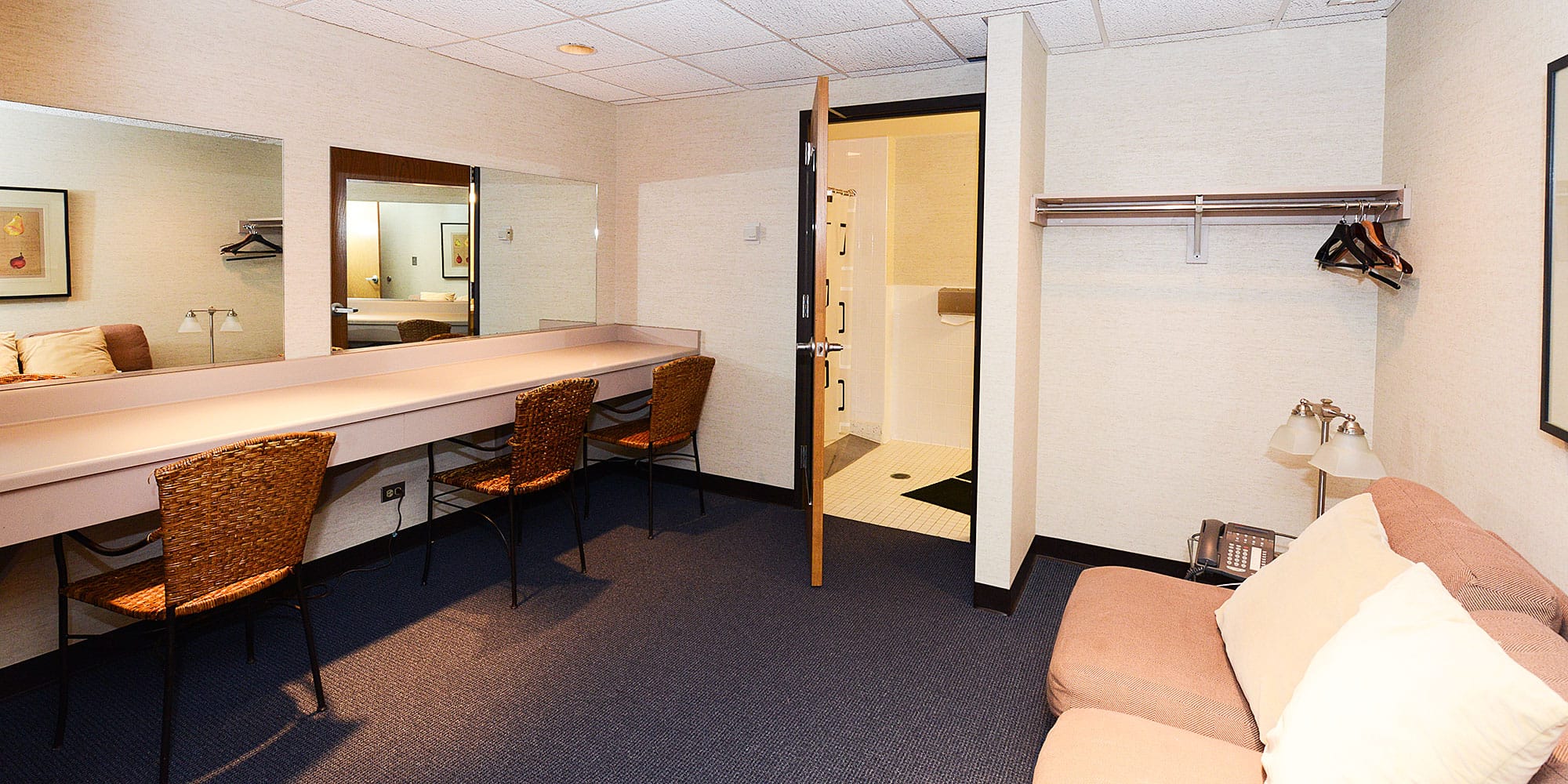 Large dressing room with several chairs and couch