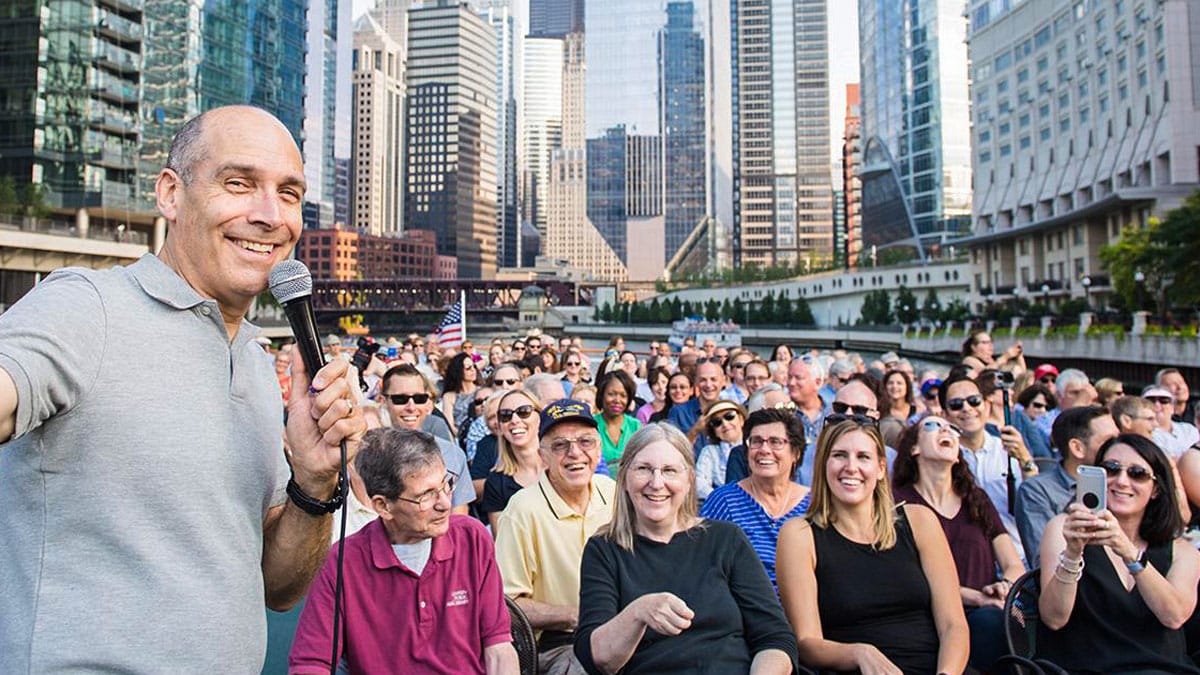 Geoffrey Baer with large group on Chicago River tour boat in downtown Chicago