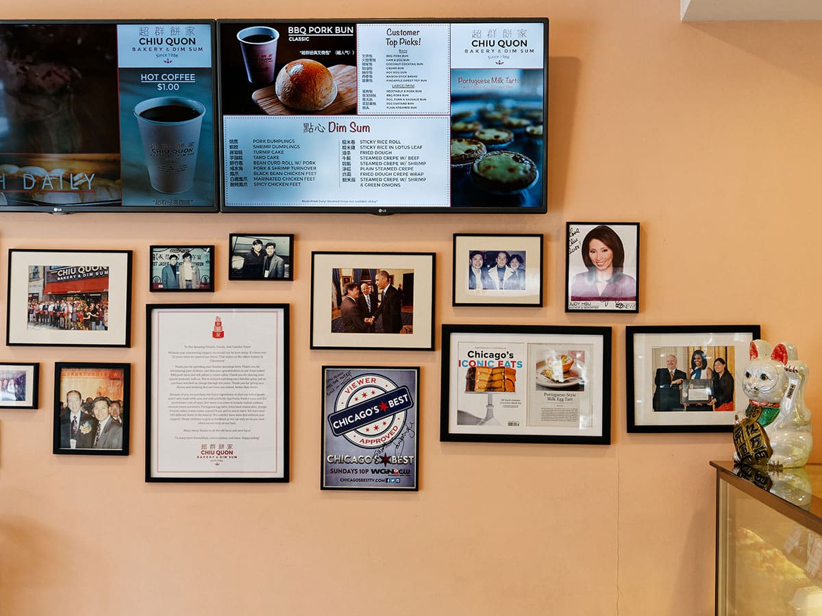 Wall of bakery showing menu as well as numerous photos and awards