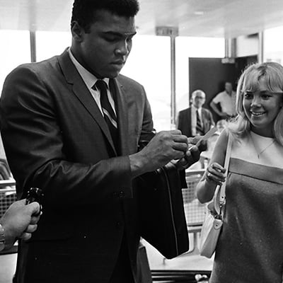 Muhammad Ali signs autographs for fans as he arrives at O'Hare Airport, Chicago, Illinois on June 21, 1967. Photo: ST-50000446-0001, Chicago Sun-Times collection, Chicago History Museum
