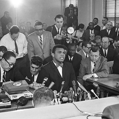 Muhammad Ali in a hearing with the Illinois Athletic Commission on February 25, 1966 over whether to cancel his fight against Ernie Terrell for Ali’s refusal to serve in the military. Photo: ST-50000293-0004, Chicago Sun-Times collection, Chicago History Museum