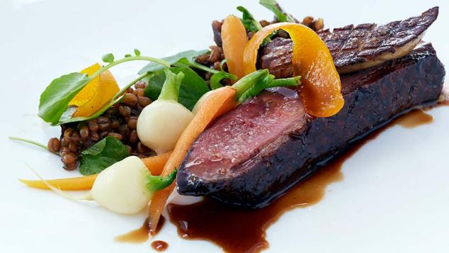 Plated duck breast with vegetables