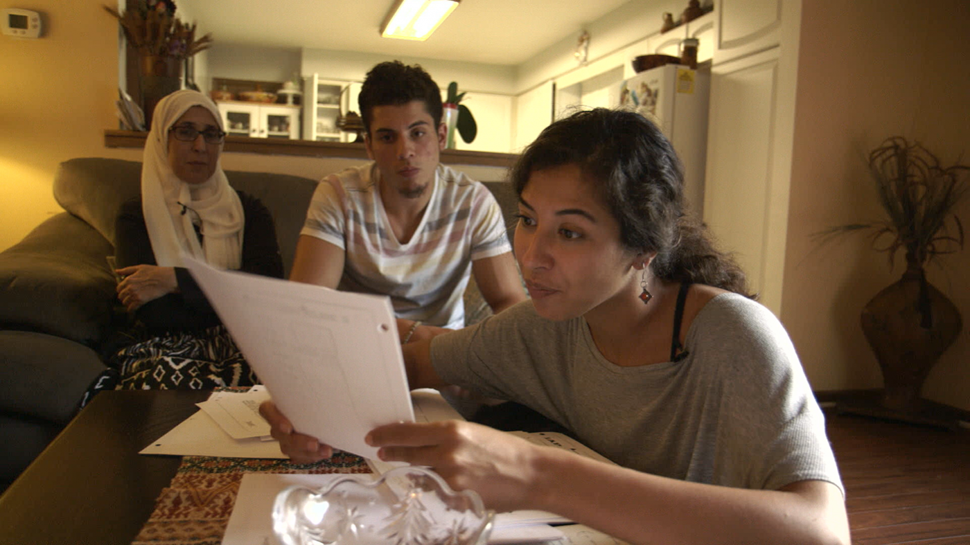 Assia Boundaoui and members of her family going over government documents about their surveillance. Image: Watched Film, LLC