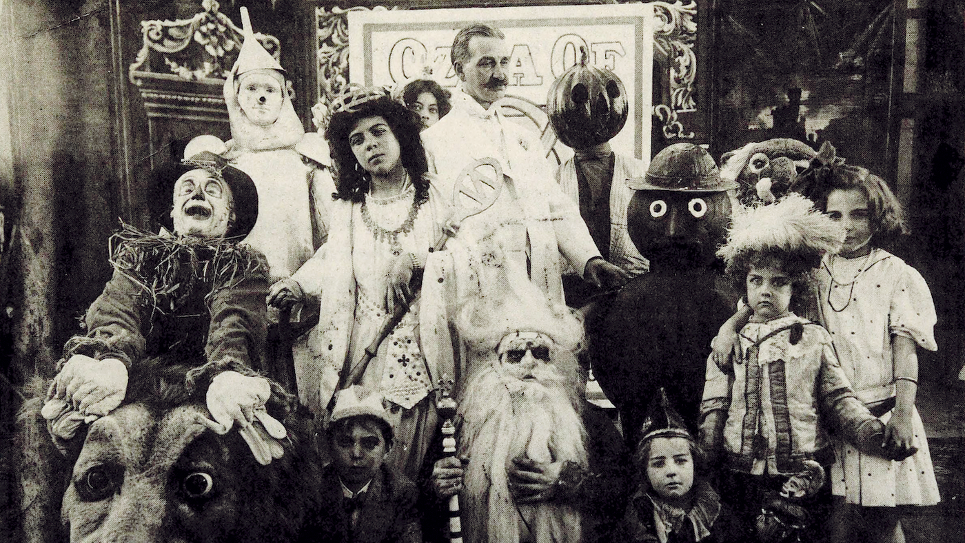 L. Frank Baum (center) surrounded by characters from The Fairylogue and Radio-Plays, a traveling multimedia Oz stage show. Circa 1908. Photo: Public Domain