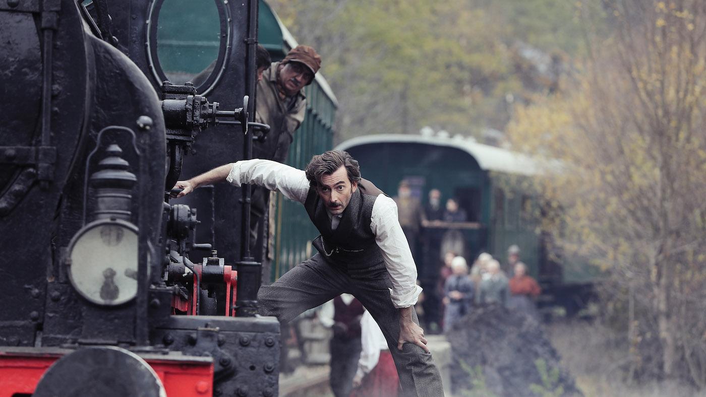 Phileas Fogg on a train through Italy in ' Around the World in 80 Days.' Photo: Tudor Cucu - © Slim 80 Days / Federation Entertainment / Peu Communications / ZDF / Be-Films / RTBF