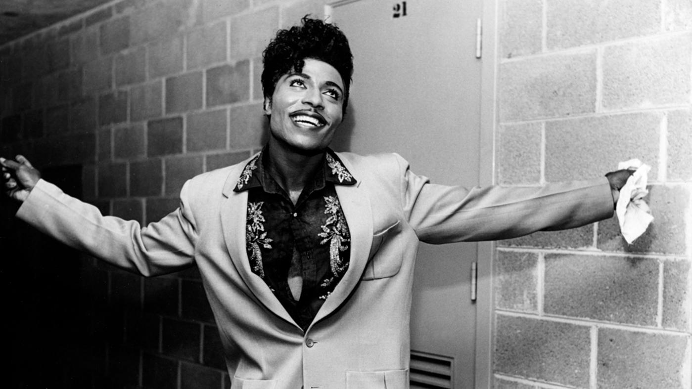 Little Richard in 1958, smiling with his arms up