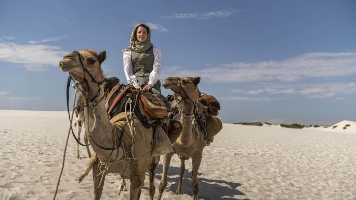 Abigail Fix rides a camel in 'Around the World in 80 Days.' Photo: Joe Alblas - © Slim 80 Days / Federation Entertainment / Peu Communications / ZDF / Be-Films / RTBF (télévision belge) 