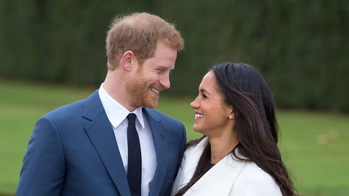 Prince Harry and Meghan Markle, wearing a white belted coat by Canadian brand Line The Label, attend a photocall in the Sunken Gardens at Kensington Palace following the announcement of their engagement on November 27, 2017 in London, England. Photo: Anwar Hussein/Getty Images