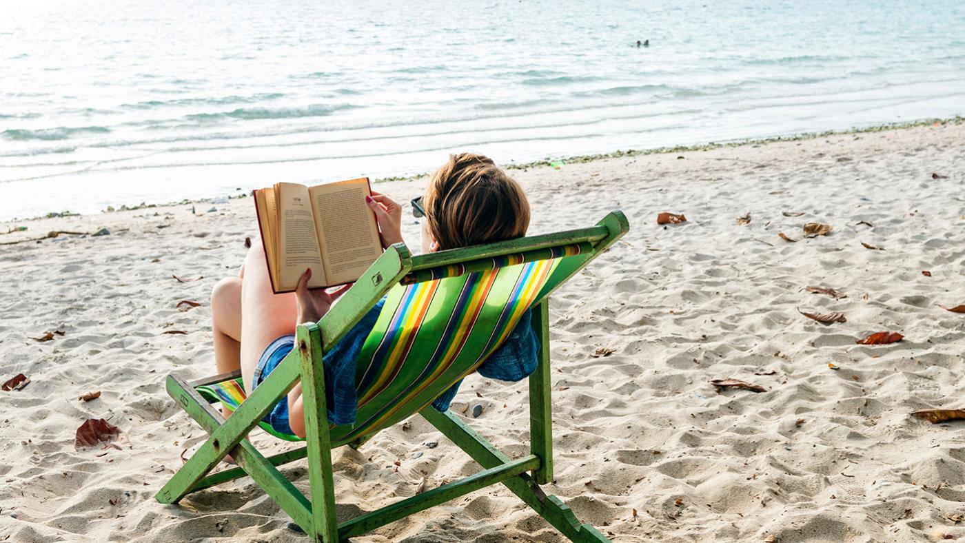 Summer reading on the beach. Photo: rawpixel on Unsplash