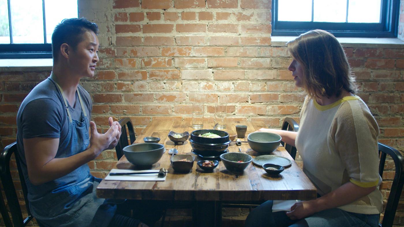 Chef Mike Lee eats Korean samgyetang and banchan with Chef Vivian Howard at his restaurant M Sushi in Durham, in 'South by Somewhere.' Photo: Blaire Johnson/Markay Media